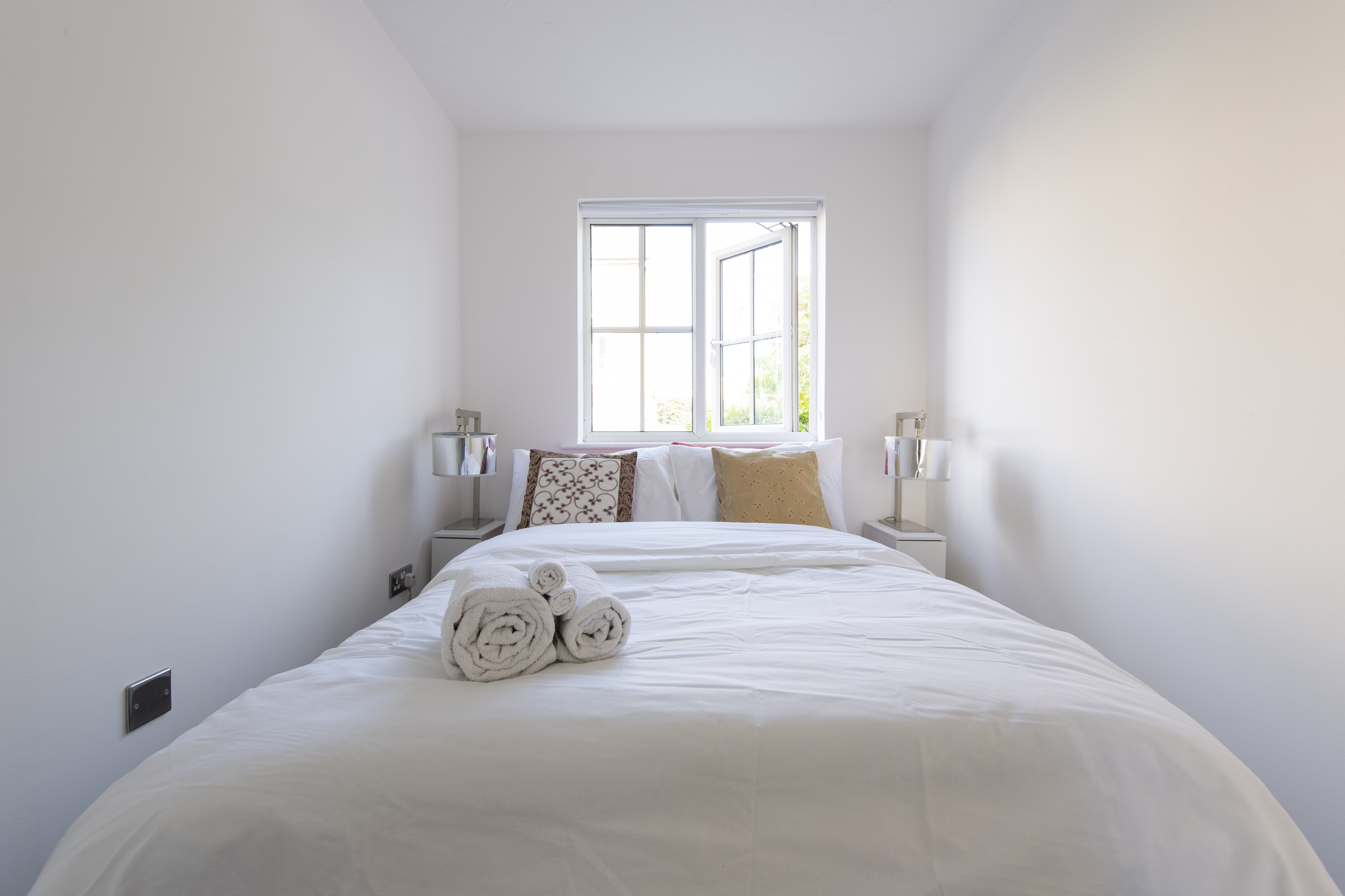 Property two — bedroom with fresh towels