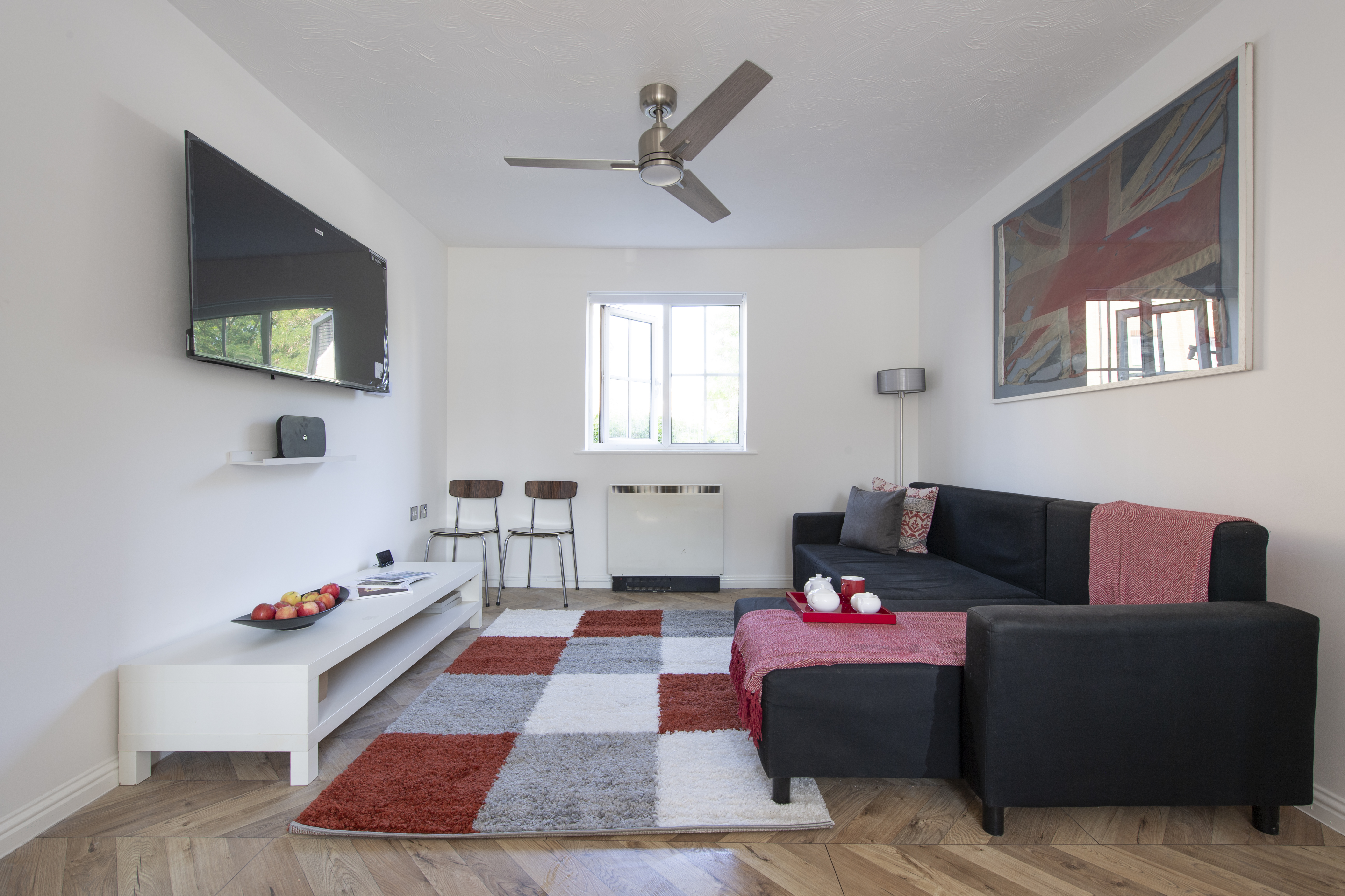 Property two — living room with sofa and TV
