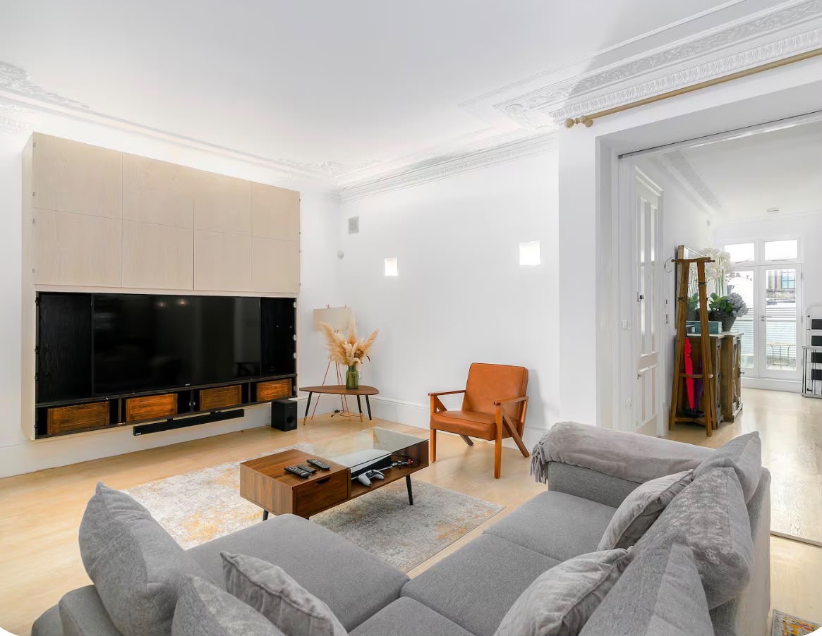 Managed property — living room with grey sofa and TV wall